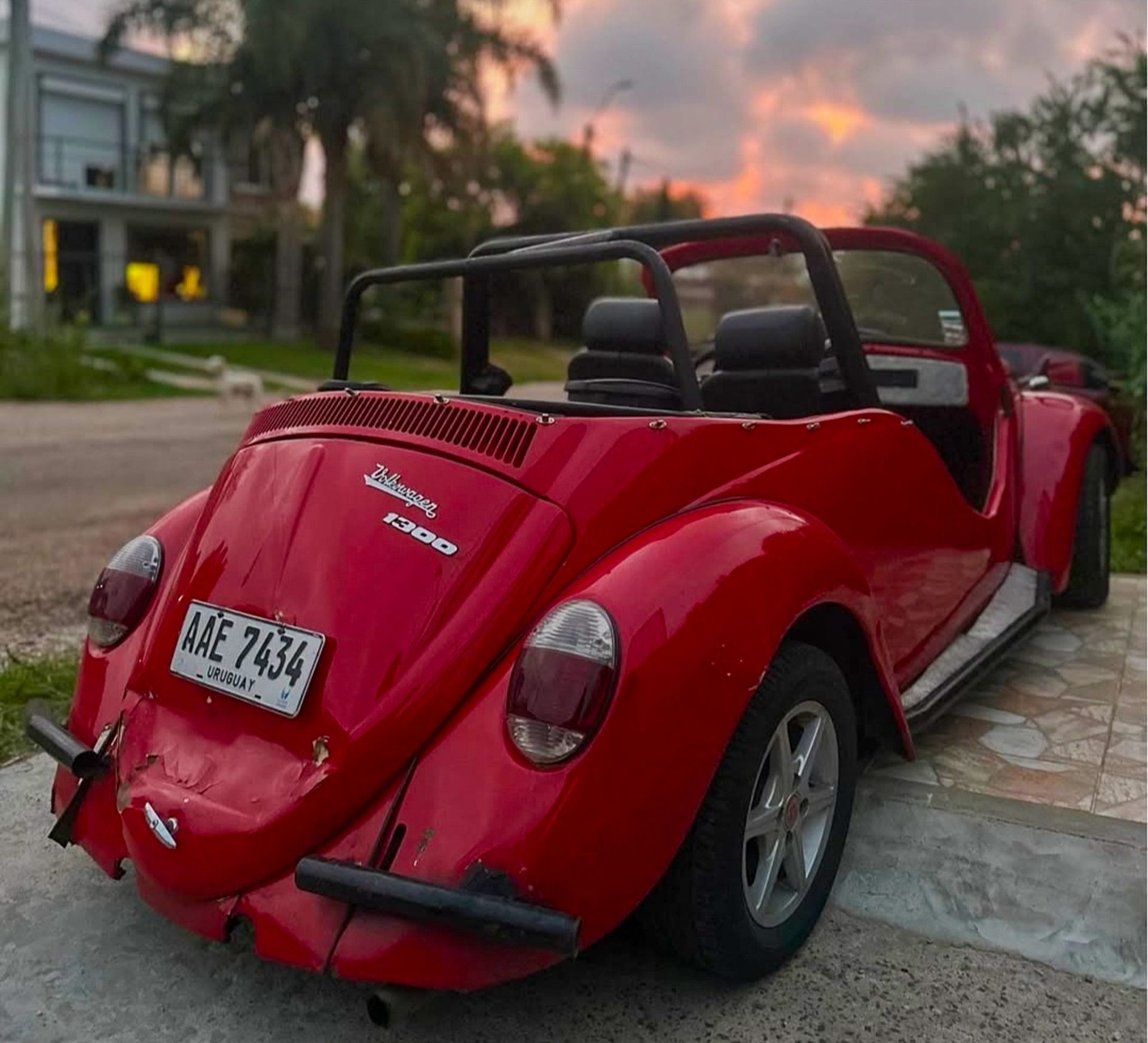 Red classic vintage convertible car parked outdoors in Uruguay